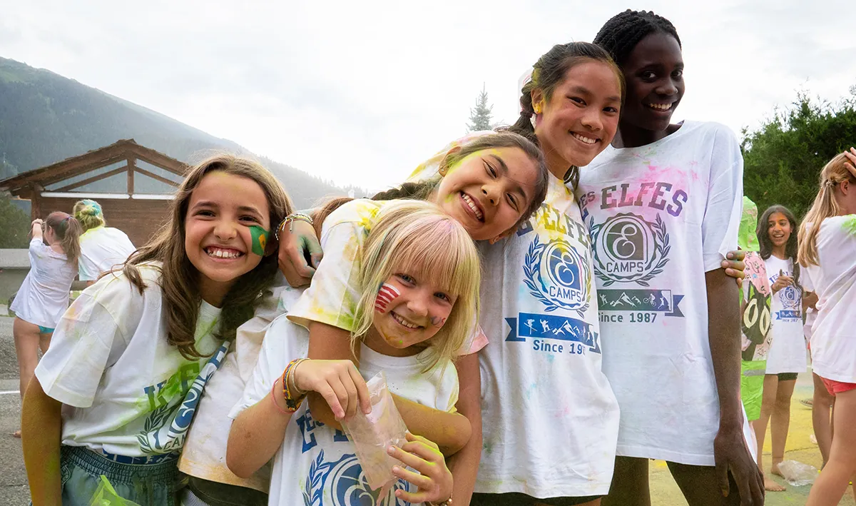 Campers smiling together at the summer Holi festival