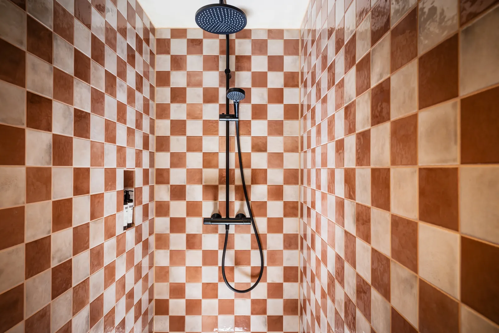 A checkered tile shower at Me and All Hotels Berlin